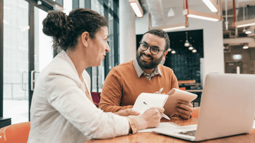 People discussing health sharing plans at a desk.
